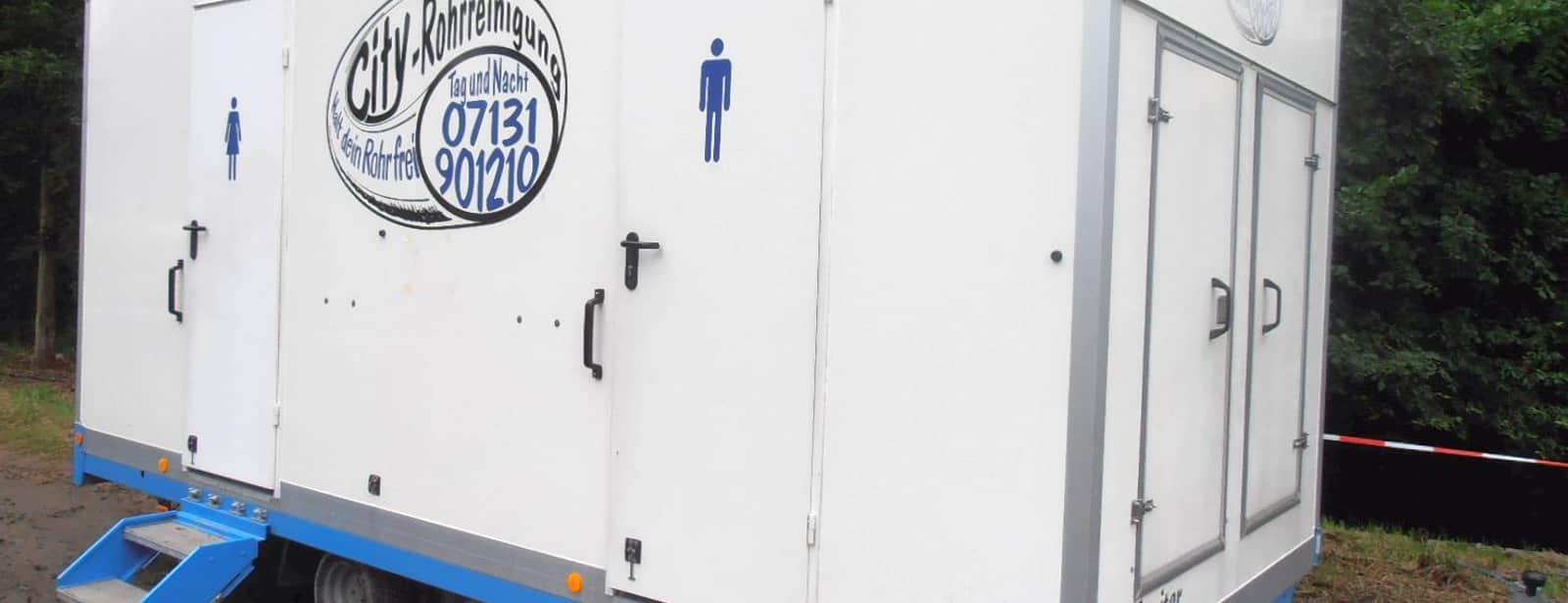 A portable restroom in service at an outdoor community festival