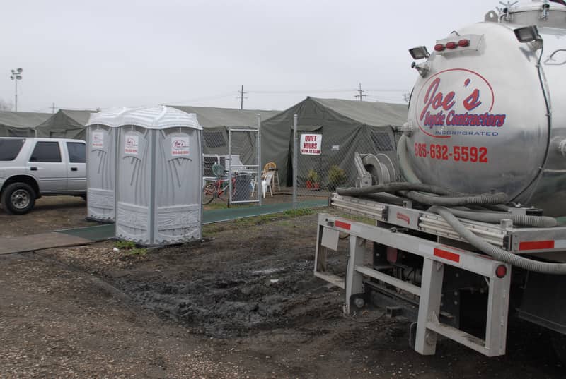 A portable restroom being transported on a service truck, the delivery step of a Minnesota portable restroom rental